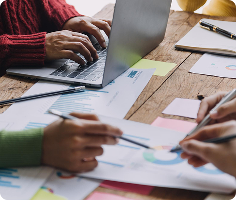 Project planning meeting with laptops and blueprints